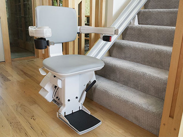 Bruno Elite straight stair lift parked at bottom of steps