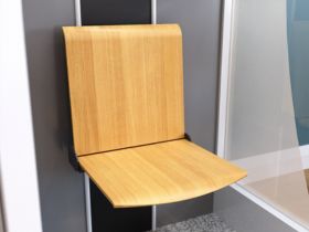 Bruno Connect home elevator's optional fold-down seat in an oak finish