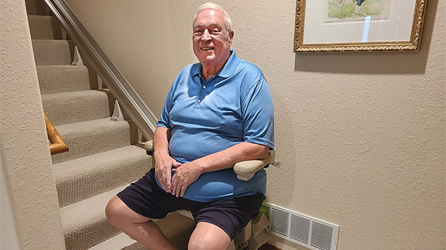 Man sitting on a Bruno Elite stairlift