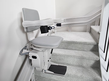 Bruno Elite curved stairlift in the middle of a staircase