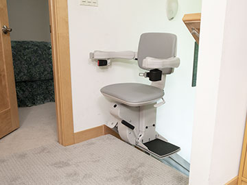 Bruno Elite straight indoor stair lift parked at top of stairs