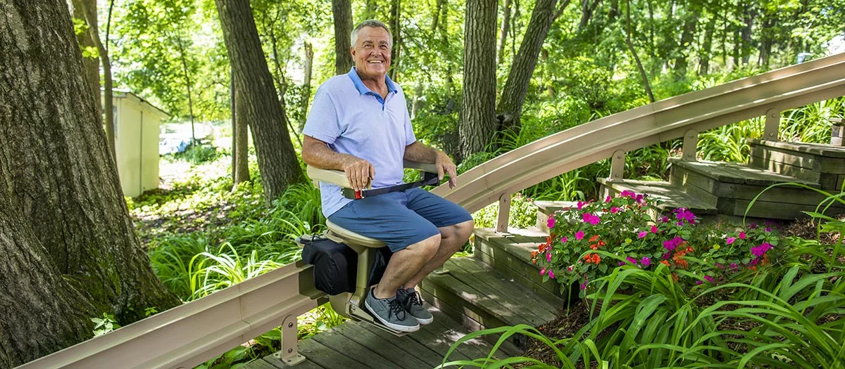 a man riding an outdoor stair lift