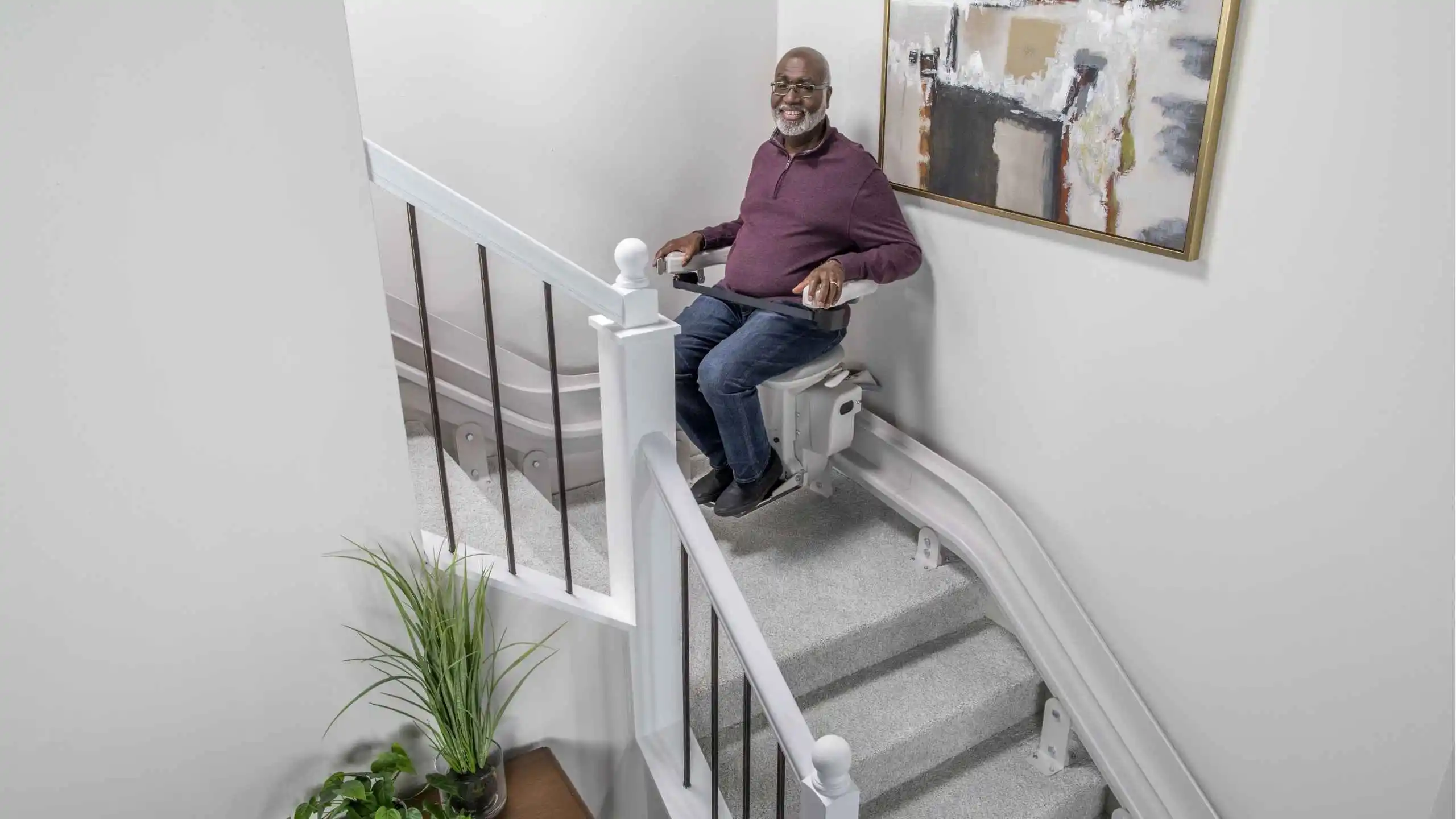 a man sitting on a stair lift