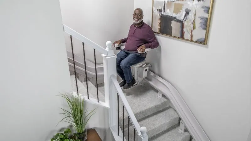 a man sitting on a stair lift