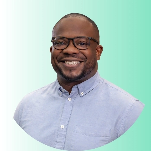 a man wearing glasses smiling