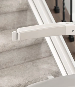 a close-up of a white handle on a staircase