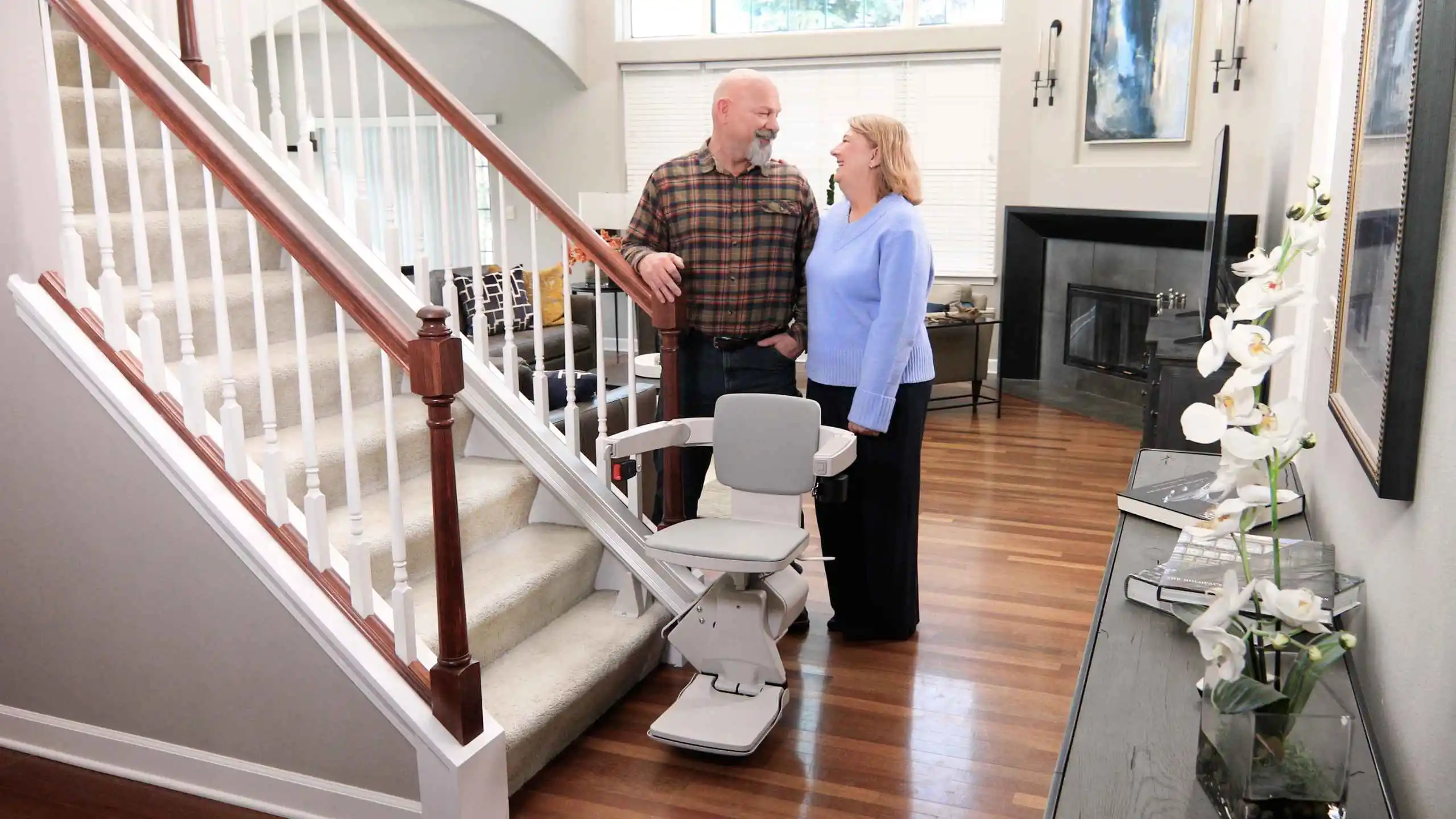 couple behind elan straight indoor stair lift