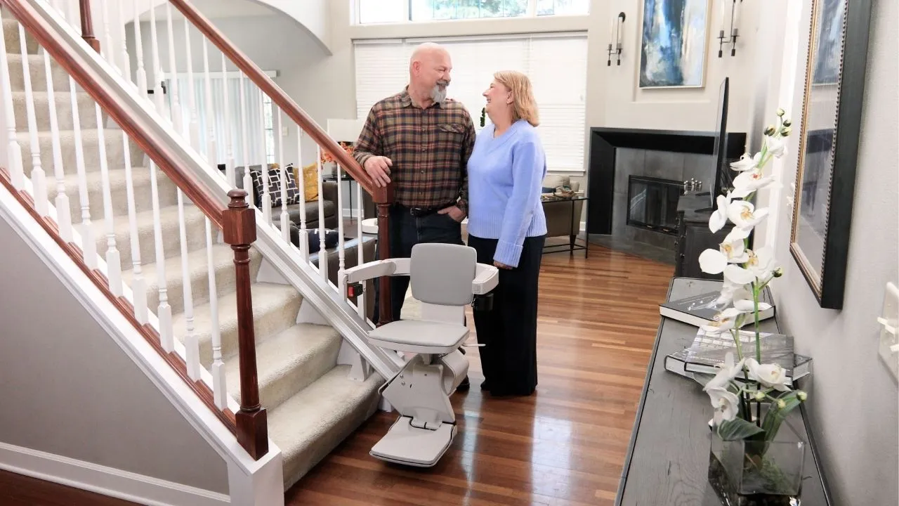 couple behind elan straight indoor stair lift