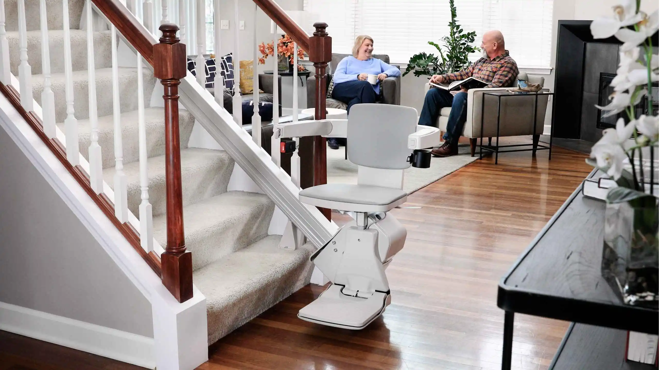 a man and woman sitting on stairs and a chair