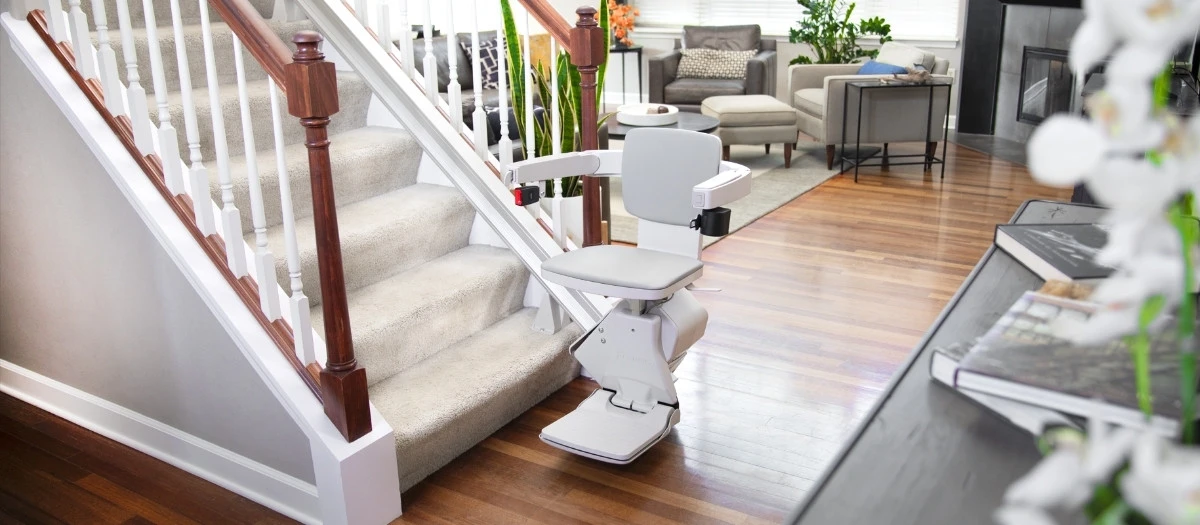 elan straight indoor stair lift with family sitting in the living room behind it
