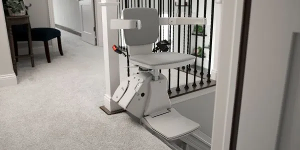 indoor straight stair lift at the top of a staircase