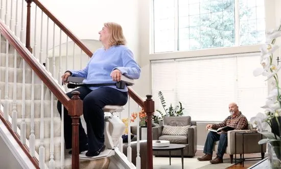 a woman sitting on a stair lift