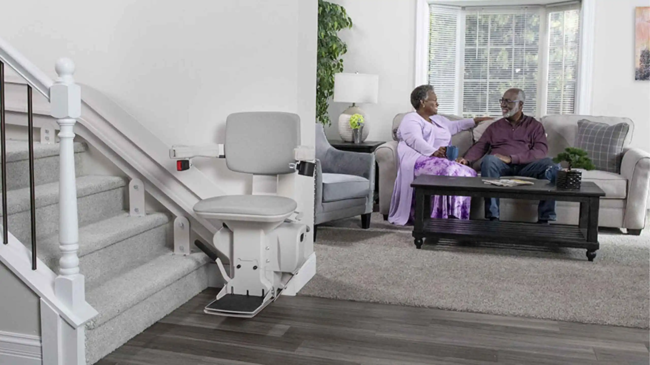 a man and woman sitting on a couch in a living room