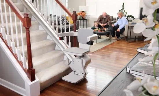 an indoor stair lift with a family playing in living room behind it