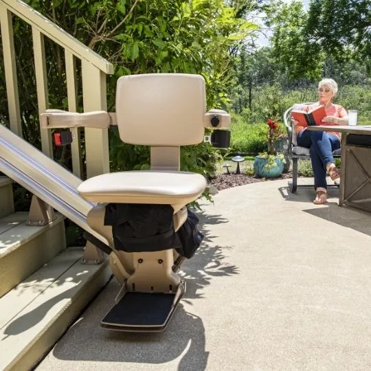 outdoor stairlift on a deck with a woman in the background