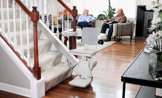 bruno elan straight stair lift with older couple in background