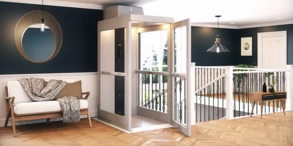 a home elevator next to the top of the staircase